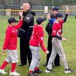 Puget Sound Fire Chief Matt Morris, left, and Kent Police Chief Rafael Padilla welcome players during Kent Little League Opening Day Saturday, April 30 at Ryan Brunner Park. COURTESY PHOTO, Puget Sound Fire