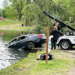 A car is pulled Tuesday morning, May 24 from the Old Fishing Hole in Kent near the Green River. The cars owner told police it somehow rolled from the parking lot into the water. The owner was not in the car when it rolled. COURTESY PHOTO, Puget Sound Fire