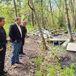King County Councilmember Reagan Dunn and Sheriffs Office deputies walk through a homeless encampment along the Green River between Kent and Auburn. COURTESY PHOTO, King County