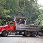 County workers cleaned trash and debris from homeless encampments and illegal dumping July 13 along the Green River Road in unincorporated King County. HENRY STEWART-WOOD, Sound Publishing