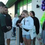 Claire Hansen, center, is handed card No. 1 on Aug. 11 outside of Amazon Fresh in Federal Way. Olivia Sullivan/the Mirror