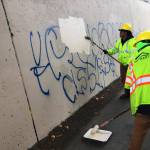 Kent city crews paint over graffiti earlier this year. COURTESY PHOTO, City of Kent