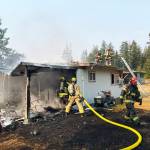 Firefighters extinguish a house fire the morning of Sept. 9 in the 27200 block of 156th Avenue SE in Kent. COURTESY PHOTO, Puget Sound Fire