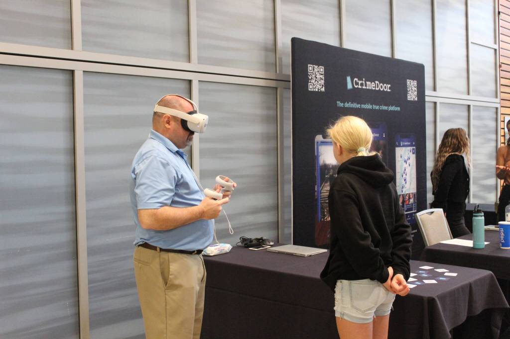 A guest is shown how to use augmented reality to explore the CrimeDoor app, a definitive mobile true crime platform that allows people to learn about and explore the sites and stories of true crime cases. Photo by Bailey Jo Josie/Sound Publishing.