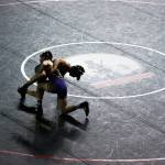 Wrestlers are silhouetted against a black wrestling mat during the Mat Classic XXXIII on Saturday, Feb. 19, 2022 in Tacoma, Washington. (Olivia Vanni / Sound Publishing)