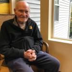 Leo Thoennes sits for a picture near his residence at the Village Green Retirement Campus in Federal Way. Photo by Alex Bruell/the Mirror