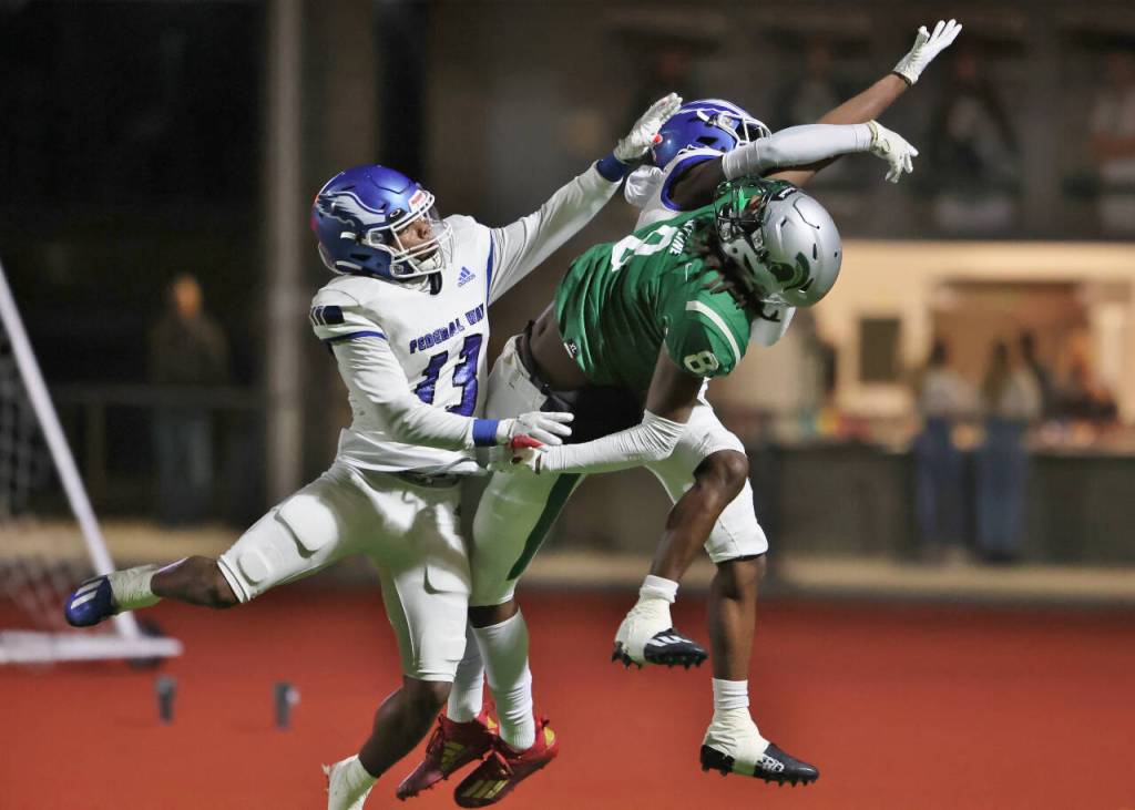 Skylines Marcus Angiuli has a pass defended by Federal Way defenders Rahshawn Clark and Zamaire Tellez. Photo courtesy of Jim Nicholson