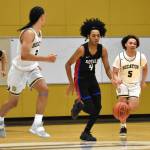 Kent-Meridian point guard Tariq Hill takes the ball up the floor against Decatur. Photo by Ben Ray/Sound Publishing