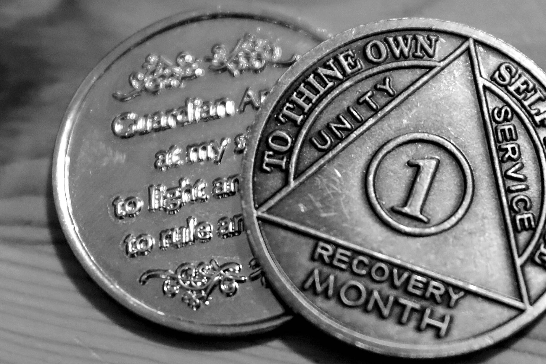 One persons month recovery coins after battling a fentanyl addiction. (Kevin Clark / The Herald)