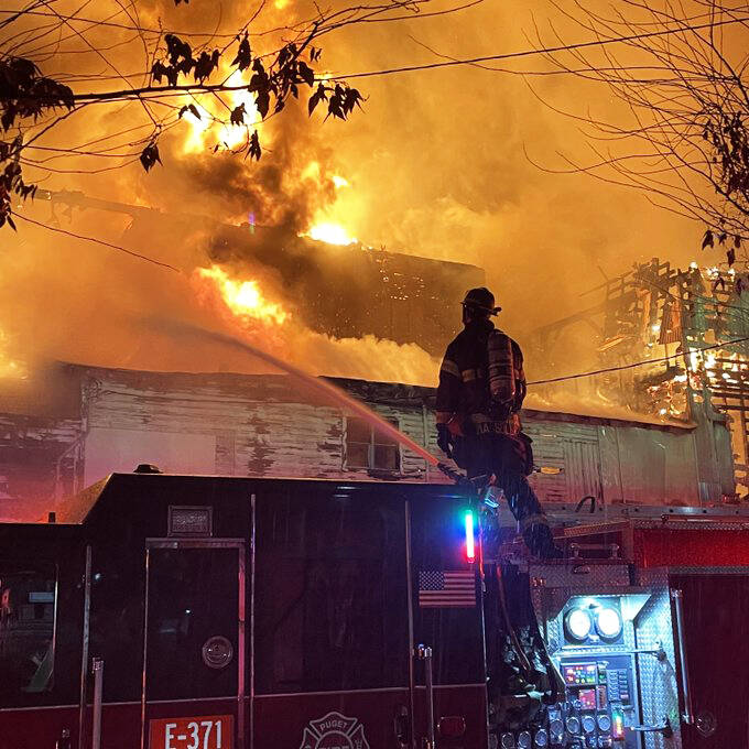 Firefighters shoot water at a Friday morning, Dec. 9 vacant warehouse fire. COURTESY PHOTO, Puget Sound Fire