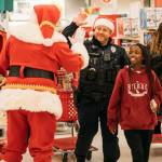 Santa Claus greets Kent Officer Sherwood and a girl Dec. 9 at Target during Shop with a Cop. COURTESY PHOTO, Kent Police