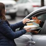 A volunteer hands out a free meal Christmas Day at Nanas Southern Kitchen in Covington. COURTESY PHOTO, Keath Crown