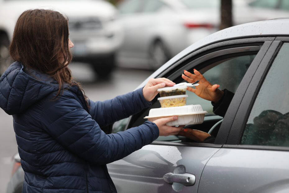 A volunteer hands out a free meal Christmas Day at Nanas Southern Kitchen in Covington. COURTESY PHOTO, Keath Crown