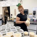 Tairyn Miller helps get meals ready to give away on Christmas Day at Nanas Southern Kitchen in Kent. COURTESY PHOTO, Todd Minor