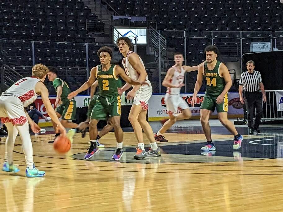 Senior Charger Jalon Blackwell fights through a screen. Photo Credit: Ben Ray/ The Reporter