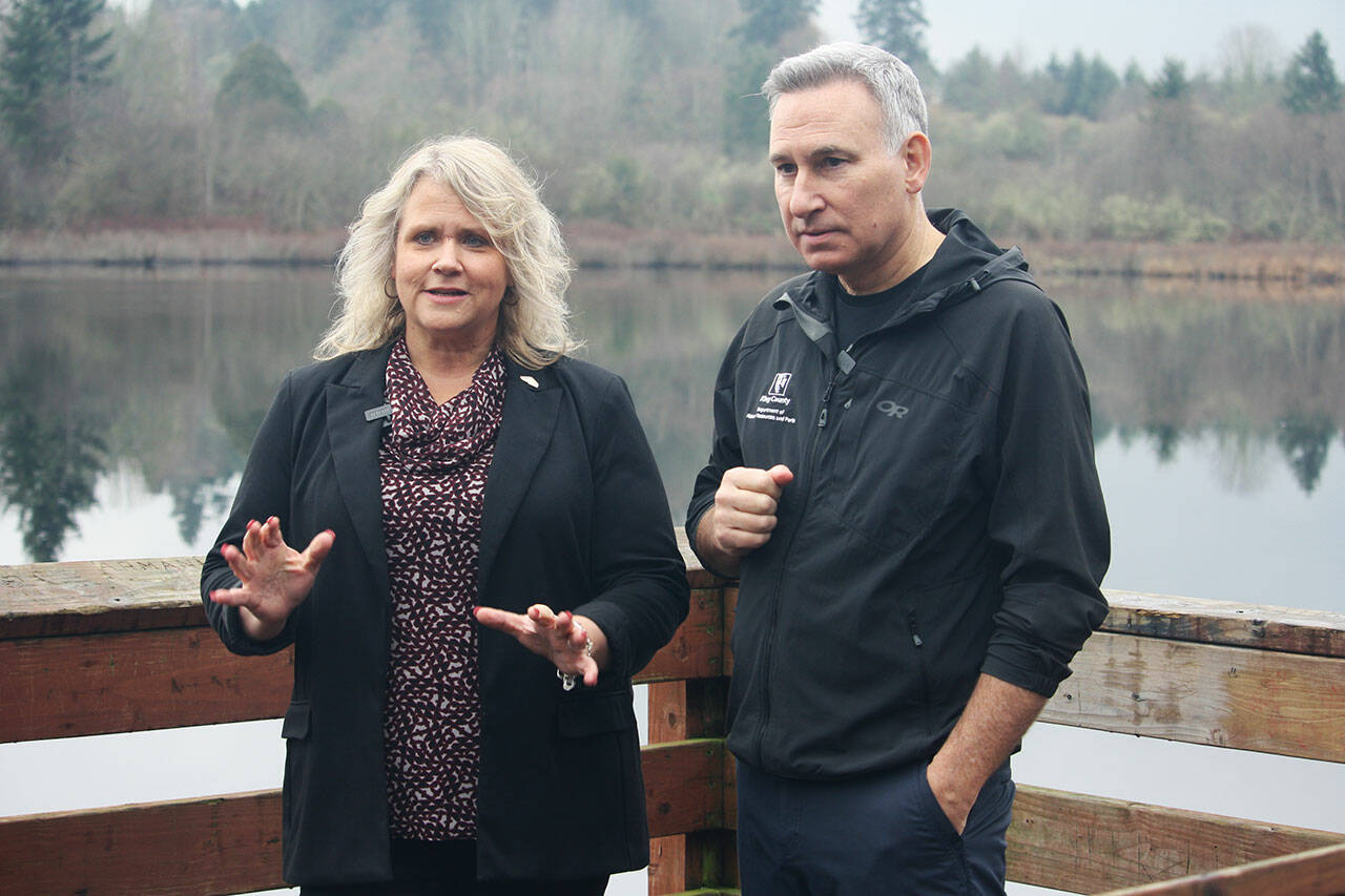 Kent Mayor Dana Ralph and King County Executive Dow Constantine chat on the dock Jan. 25 at Clark Lake Park. STEVE HUNTER, Kent Reporter