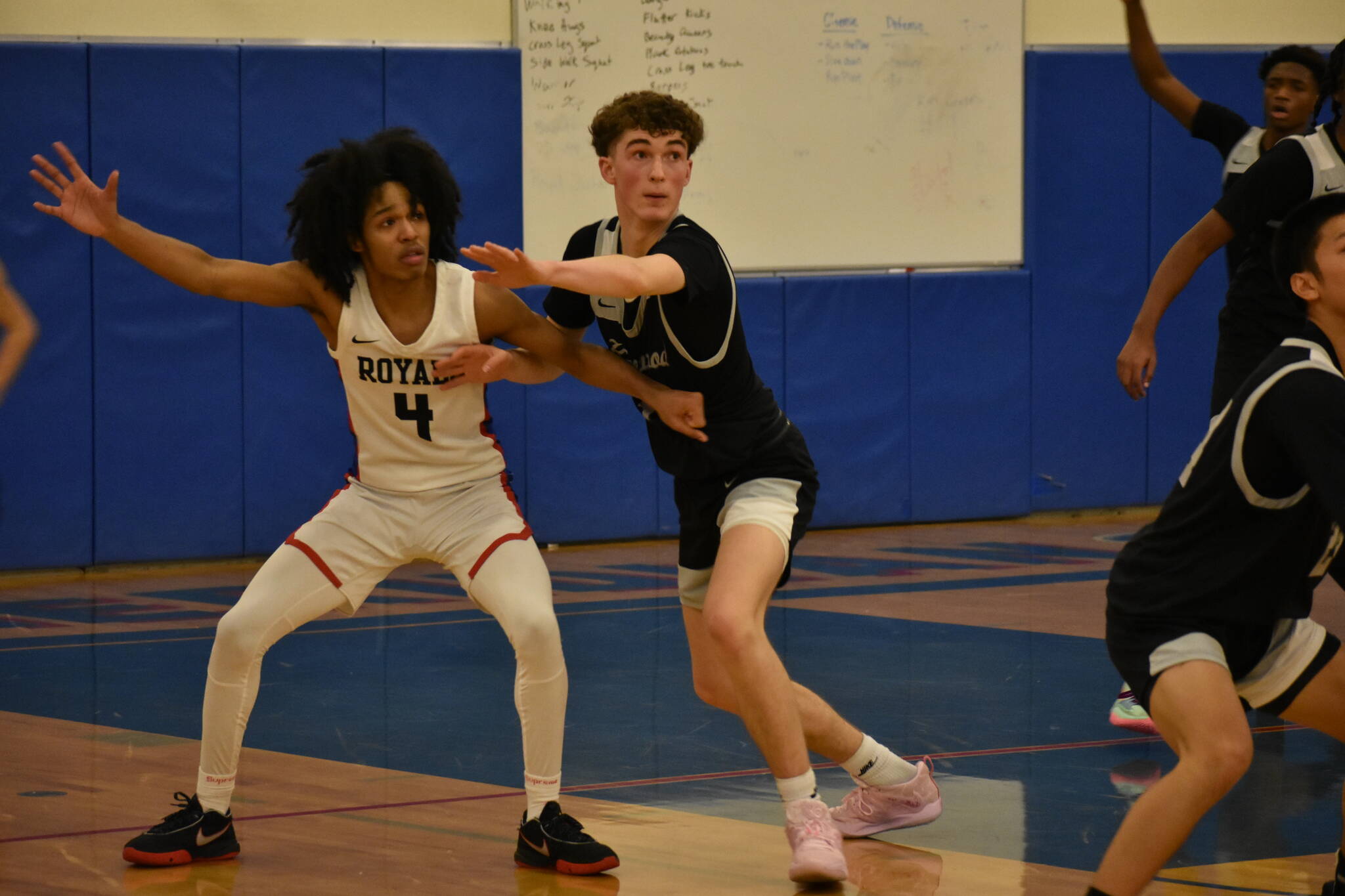 Kentwood junior Blake Stempniak guarding Kent Meridians Tariq Hill. Photo Credit: Ben Ray/ The Reporter