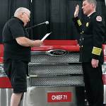 Les Thomas, chair of the Puget Sound Fire Governance Board, swears in new Chief Brian Carson. COURTESY PHOTO, Puget Sound Fire