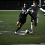 Armani Albert runs down the sideline with a defender draped all over him.