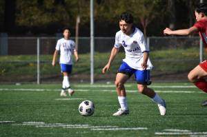 Sophomore Irving Baca-Silva takes on a Raider defender in the first half. Ben Ray / The Reporter