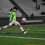 Kent-Meridian sophomore Edgar Govea punts the ball. Ben Ray / The Reporter