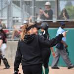 Head Coach Sydney Eacret points to fans after a solid inning for Kentwood. Ben Ray / The Reporter