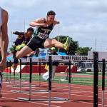 Senior Alex Conner leaps over a hurdle on his way to first place. Ben Ray / The Reporter