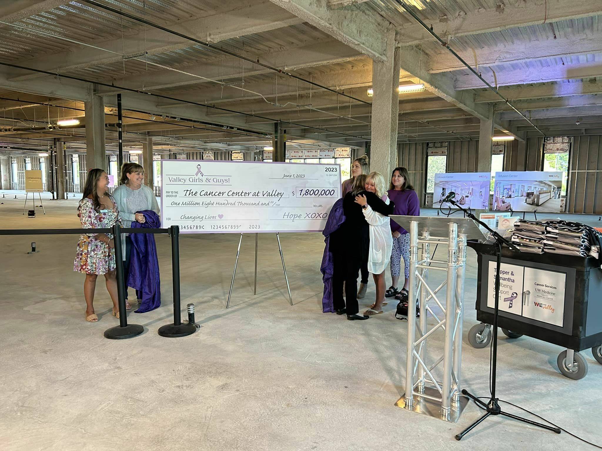 Valley Medical CEO Jeannine Erickson-Grinnell hugs Valley Girls & Guys Founder Tina McDonough after being presented with the Cancer Centers first gift. Photo courtesy of Valley Medical Center.