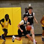Brandon Tagle makes a dribble move on a fast break for the Kentwood summer league team. BEN RAY, The Reporter