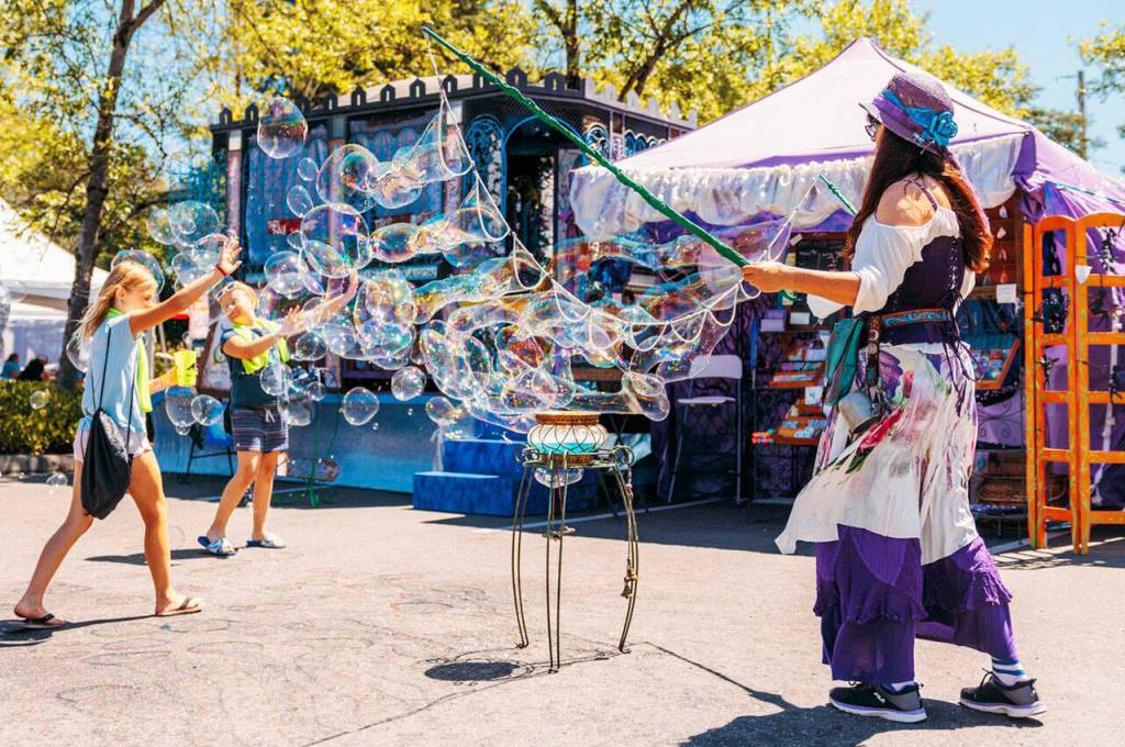 Children enjoy bubbles in the air while walking the downtown streets during Kent Cornucopia Days. COURTESY PHOTO, City of Kent