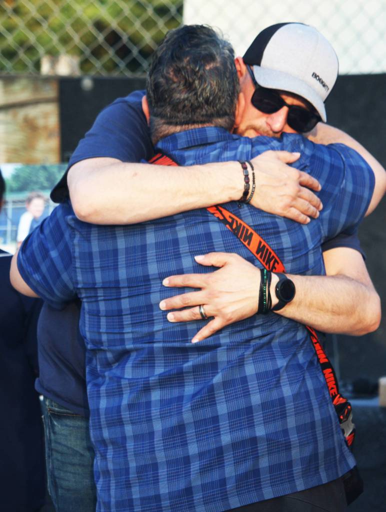 Michael Coury, the father of Gabriel, receives a hug. STEVE HUNTER, Kent Reporter