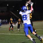 Kent-Meridian Junior Kyle Brown goes up for a jump ball in the 32-29 victory. 
Ben Ray
Sound Publishing
