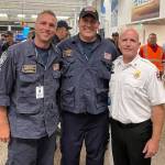 Puget Sound Fire Capt. Tyler Kuske, left, and Battalion Chief Andy Nevens, center, are welcomed home Aug. 26 at Sea-Tac Airport by Assistant Chief Dan Conroy after their rescue help in Maui. COURTESY PHOTO, Puget Sound Fire