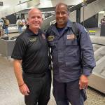 Kent-based Puget Sound Fire Assistant Chief Dan Conroy, left, welcomes home Capt. Martin Oliver Aug. 29 at Sea-Tac Airport after his work with Washington State Task Force 1 in Maui. COURTESY PHOTO, Puget Sound Fire