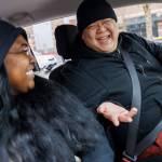 Two people enjoy each others company and laugh on their Vanpool commute. Photo courtesy of TC Hawthorne