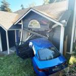 A car crashed into a Kent home Friday, Oct. 6 in the 11600 block of SE 223rd Drive. One person inside the home suffered minor injuries. COURTESY PHOTO, Puget Sound Fire