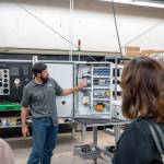 Harry Millan, the panel shop designer/manager for Motors and Controls in Kent, shows off the panel for a 100-horsepower motor on a water jet cutting machine. COURTESY PHOTO, Brian Mittge/Association of Washington Business
