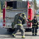 Carrying a hose is part of the training for recruit firefighters. COURTESY PHOTO, Puget Sound Fire