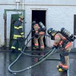 Recruit firefighters prepare to enter a building during training. COURTESY PHOTO, Puget Sound Fire