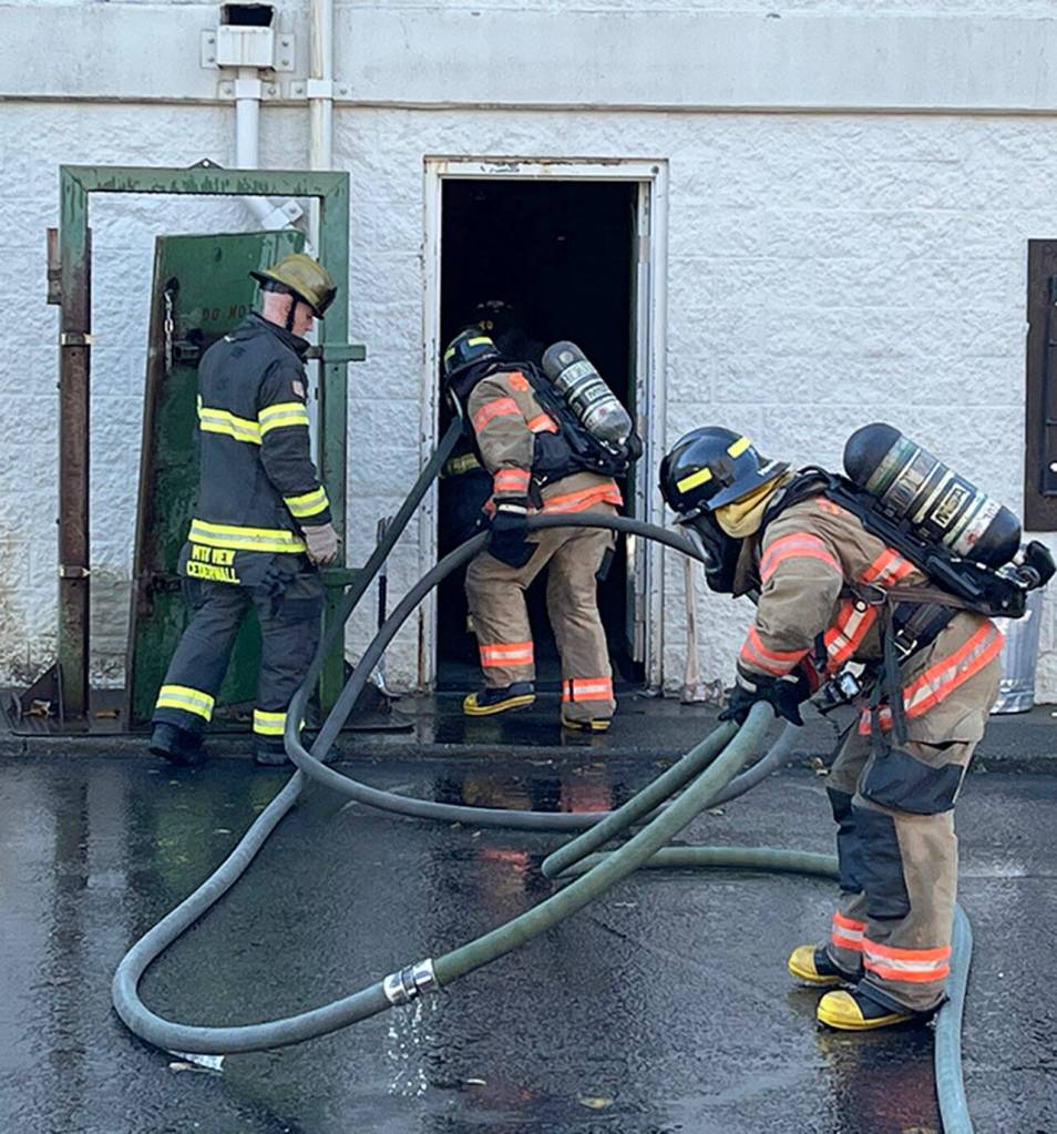 Recruit firefighters prepare to enter a building during training. COURTESY PHOTO, Puget Sound Fire