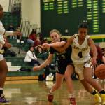 Sydney Esperanza (White) and Natalie Brown (Black) battle in the lane. Ben Ray / The Reporter