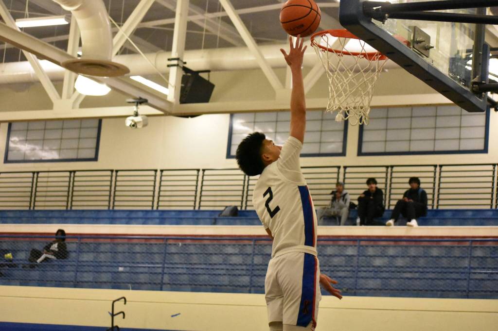 Royals Joel Remos with a finger-roll layup against Auburn Riverside. Ben Ray / The Reporter