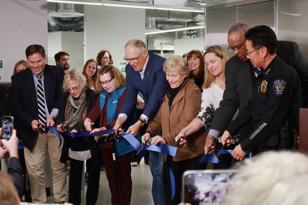 Local leaders help cut the ribbon at the Federal Way toxicology lab opening event. From left to right: Mayor Jim Ferrell, Sen. Claire Wilson, Deputy Mayor Susan Honda, Gov. Jay Inslee, Council President Linda Kochmar, Dr. Fiona Couper, director of the Forensic Laboratory Services Bureau, WSP Chief John Batiste and Federal Way Police Chief Andy Hwang. (Photo by Keelin Everly-Lang / The Reporter)