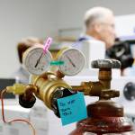 A sticky note reminds the visiting guests not to touch any equipment or turn any knobs during the toxicology lab tour. Photo by Keelin Everly-Lang / The Reporter
