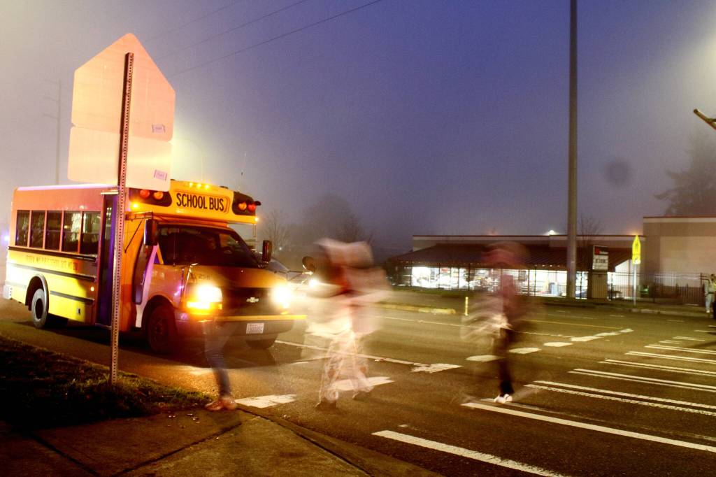 School bus routes go through the busy intersection of 308th Street and Pacific Highway South in front of Federal Way High School on Dec. 18. Students are advocating for changes to these routes to protect pedestrians heading to school. (Photo by Keelin Everly-Lang / Sound Publishing)