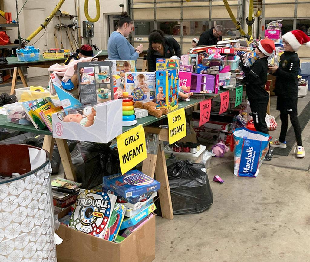 Volunteers sort toys donated for the Toys for Joy program. COURTESY PHOTO, Puget Sound Fire