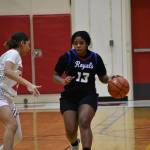 Senior Kamiah Ware bring the ball up the court against Renton. Ben Ray / The Reporter