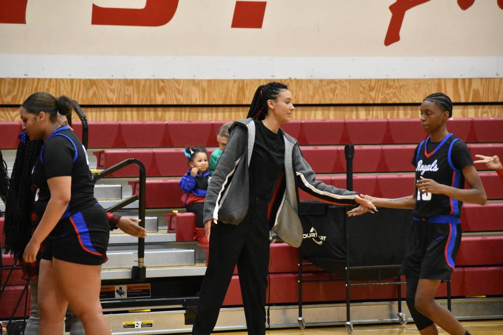 Head Coach Morganne Comstock giving some love to Sade Oyebiyi during a timeout.