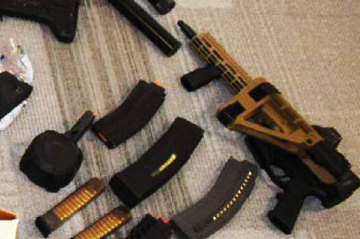 Illegal guns and ammunition reportedly discovered at the home and storage unit of a Black Diamond couple. COURTESY PHOTO, U.S. Department of Justice