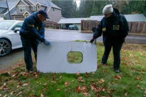 The plane door that flew off of the Alaska Airlines flight 1282 Boeing 737-9 MAX found by NTSB investigators in a Portland residents backyard. (Courtesy of NTSB)